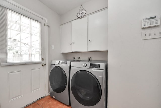 1903 Britton St, Baytown, TX 77520 - laundry room featuring separate washer and dryer, cabinet space, and light tile patterned floors