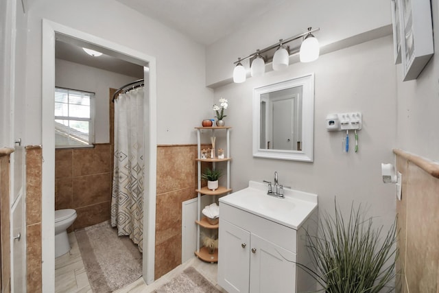 1903 Britton St, Baytown, TX 77520 - bathroom with tile walls, vanity, a wainscoted wall, and curtained shower