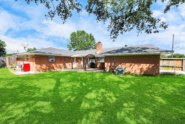 1903 Britton St, Baytown, TX 77520 - rear view of house with a patio, a chimney, and brick siding
