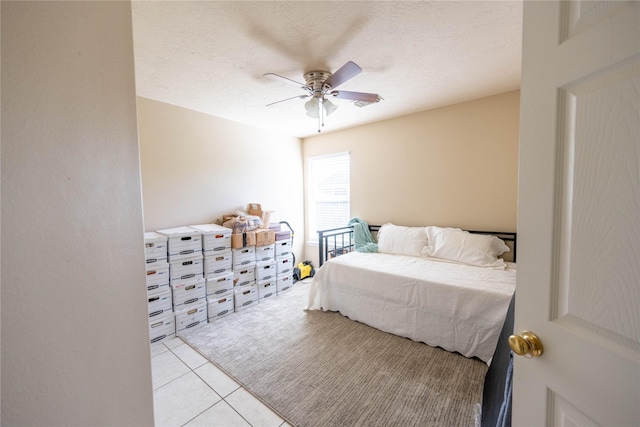 1409 Barras St, Alvin, TX 77511 - bedroom featuring a ceiling fan, light tile patterned floors, and a textured ceiling