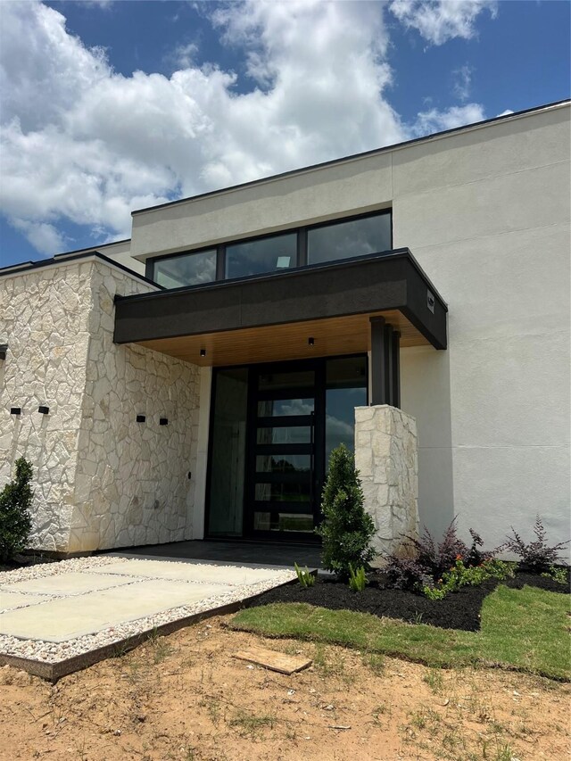 20410 Tealpointe Ridge Ln, Tomball, TX 77377 - doorway to property featuring stucco siding and stone siding