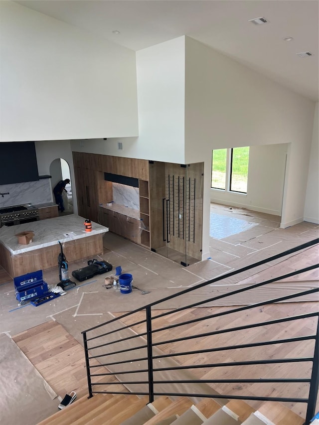 20410 Tealpointe Ridge Ln, Tomball, TX 77377 - unfurnished living room with high vaulted ceiling and arched walkways