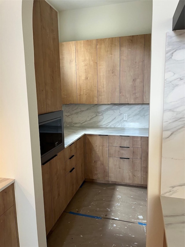 20410 Tealpointe Ridge Ln, Tomball, TX 77377 - kitchen with stainless steel microwave, light countertops, and modern cabinets