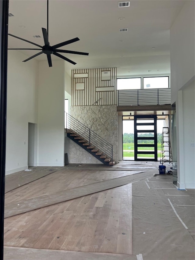 20410 Tealpointe Ridge Ln, Tomball, TX 77377 - unfurnished living room with a high ceiling, ceiling fan, and wood-type flooring