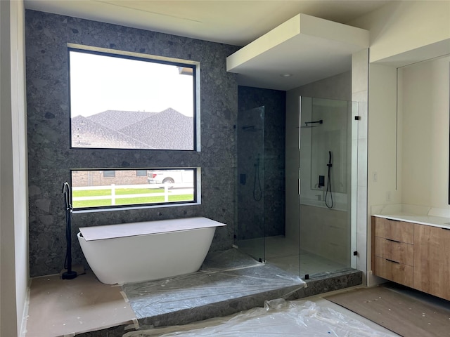 20410 Tealpointe Ridge Ln, Tomball, TX 77377 - bathroom featuring plenty of natural light, a stall shower, a freestanding tub, and vanity
