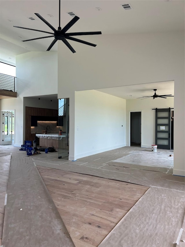 20410 Tealpointe Ridge Ln, Tomball, TX 77377 - unfurnished living room with a high ceiling and a ceiling fan