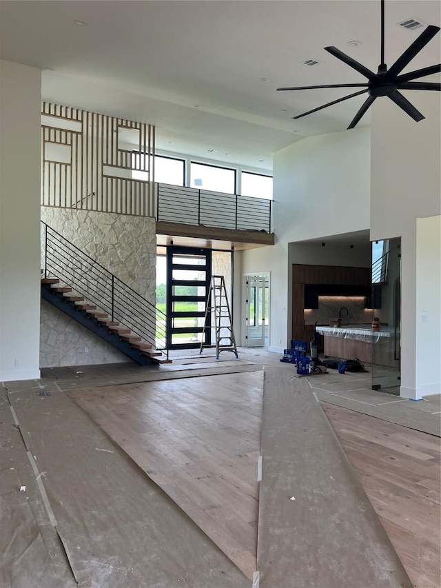 20410 Tealpointe Ridge Ln, Tomball, TX 77377 - living room with a high ceiling, stairs, and ceiling fan