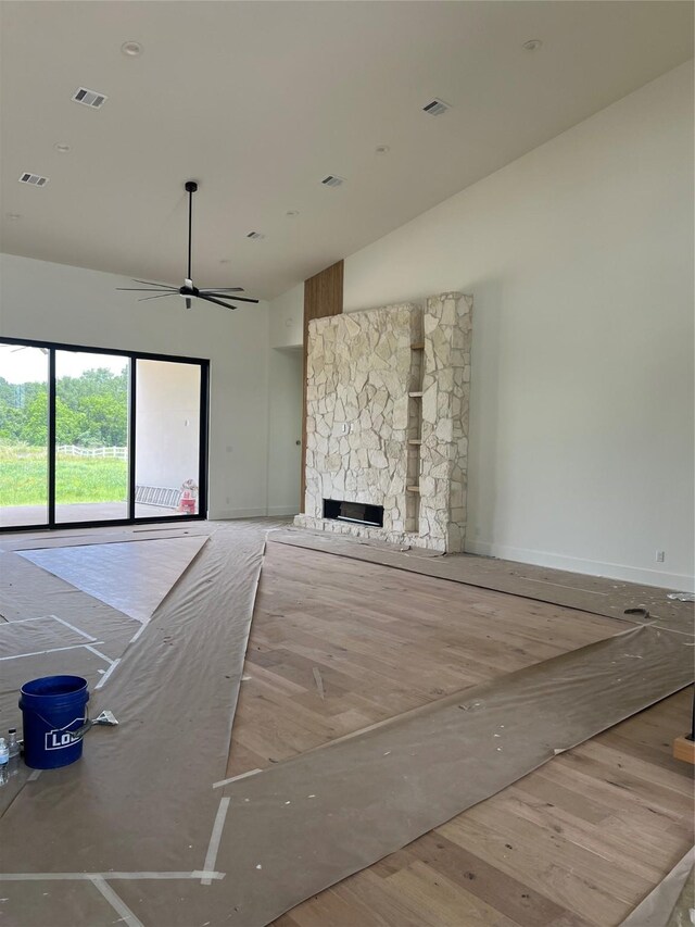 20410 Tealpointe Ridge Ln, Tomball, TX 77377 - unfurnished living room with a fireplace, lofted ceiling, and a ceiling fan