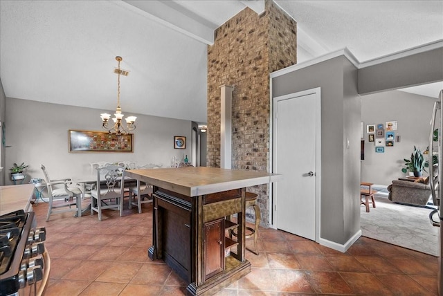 2004 Tuscarora Ct, League City, TX 77573 - kitchen with stainless steel gas range oven, dark brown cabinets, a chandelier, hanging light fixtures, and a kitchen breakfast bar