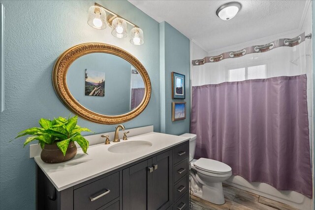 2004 Tuscarora Ct, League City, TX 77573 - full bathroom featuring vanity, wood finished floors, shower / bathtub combination with curtain, a textured wall, and a textured ceiling