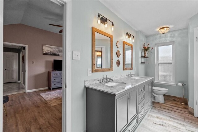 2004 Tuscarora Ct, League City, TX 77573 - full bath with double vanity, wood finished floors, vaulted ceiling, and ceiling fan