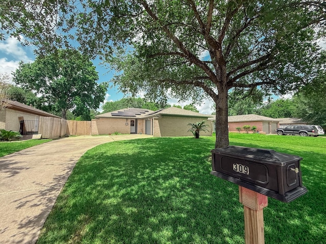 309 Baycrest Dr, League City, TX 77573 - view of front of property with concrete driveway, roof mounted solar panels, and brick siding
