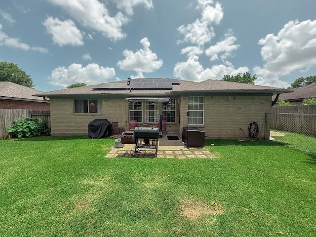 309 Baycrest Dr, League City, TX 77573 - rear view of house with brick siding, a fenced backyard, a patio, and roof mounted solar panels