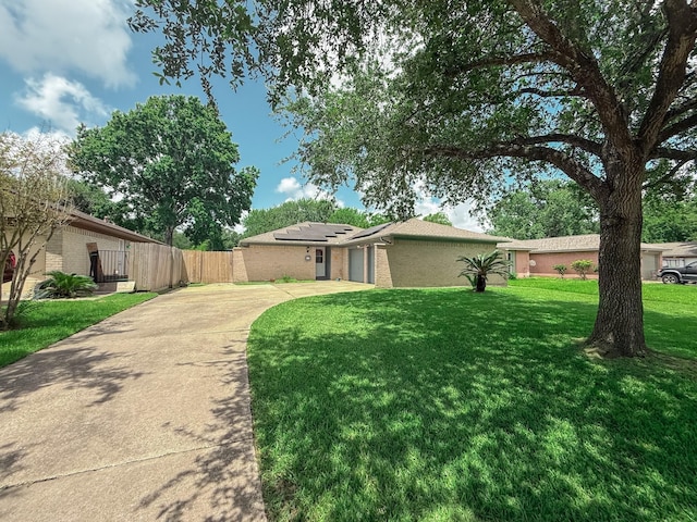 309 Baycrest Dr, League City, TX 77573 - view of front of home featuring concrete driveway, solar panels, an attached garage, brick siding, and a gate