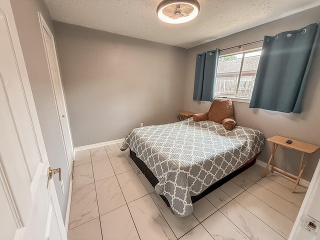309 Baycrest Dr, League City, TX 77573 - bedroom featuring marble finish flooring and a textured ceiling