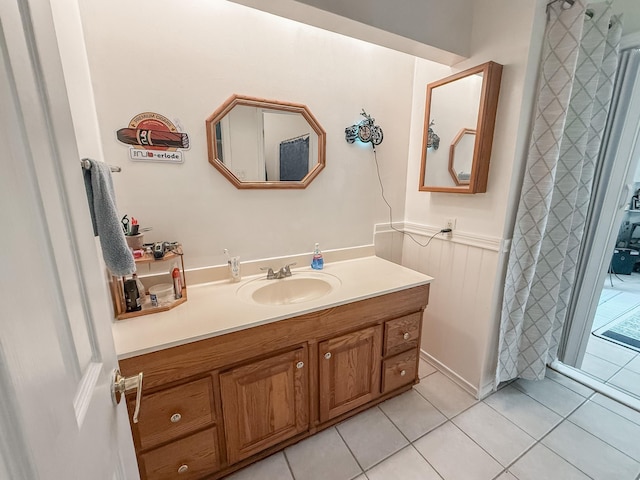309 Baycrest Dr, League City, TX 77573 - bathroom with vanity, tile patterned flooring, and wainscoting