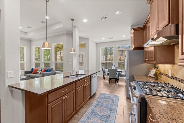 14 Painted Post Pl, The Woodlands, TX 77389 - kitchen with appliances with stainless steel finishes, under cabinet range hood, backsplash, stone counters, and recessed lighting