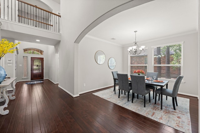 14 Painted Post Pl, The Woodlands, TX 77389 - dining room with a chandelier, arched walkways, hardwood / wood-style flooring, and crown molding