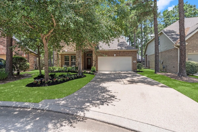 14 Painted Post Pl, The Woodlands, TX 77389 - obstructed view of property featuring brick siding, a front lawn, driveway, and an attached garage