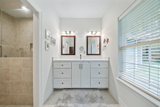 6602 Ranch Park Dr, Magnolia, TX 77354 - bathroom featuring vanity, tiled shower, and tile patterned flooring