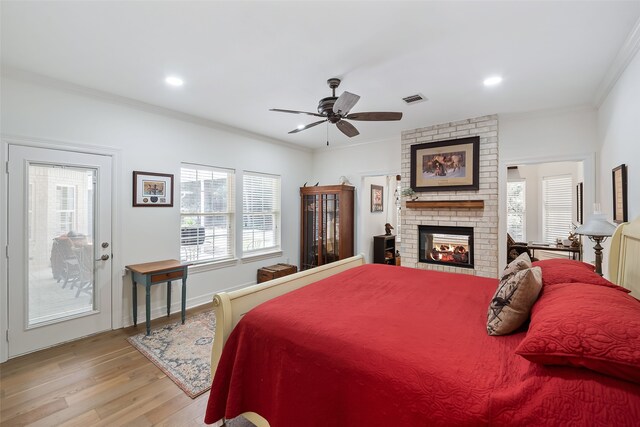 6602 Ranch Park Dr, Magnolia, TX 77354 - bedroom featuring light wood-style flooring, ornamental molding, a brick fireplace, recessed lighting, and ceiling fan