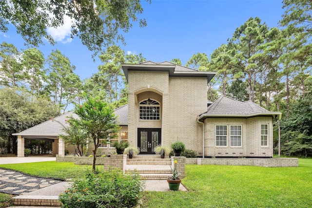 6602 Ranch Park Dr, Magnolia, TX 77354 - view of front facade featuring french doors, a front yard, brick siding, and a shingled roof