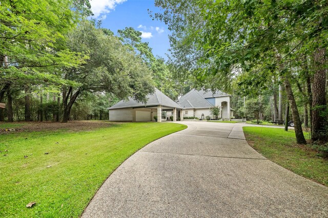 6602 Ranch Park Dr, Magnolia, TX 77354 - view of front of property featuring a front lawn, driveway, and a garage