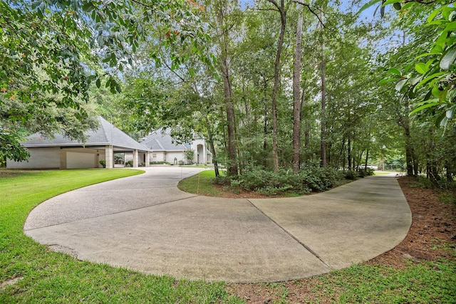 6602 Ranch Park Dr, Magnolia, TX 77354 - view of front of property featuring a front lawn, concrete driveway, and a garage