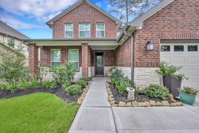 2411 Sunset Mist Ln, Conroe, TX 77304 - view of front of home featuring brick siding, an attached garage, and a front yard