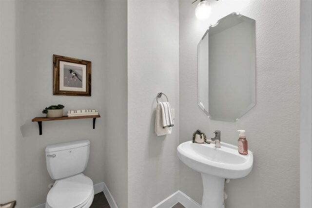 2411 Sunset Mist Ln, Conroe, TX 77304 - half bath featuring toilet and baseboards