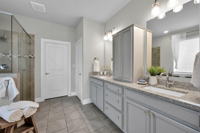 2411 Sunset Mist Ln, Conroe, TX 77304 - bathroom featuring double vanity, a shower stall, and tile patterned flooring