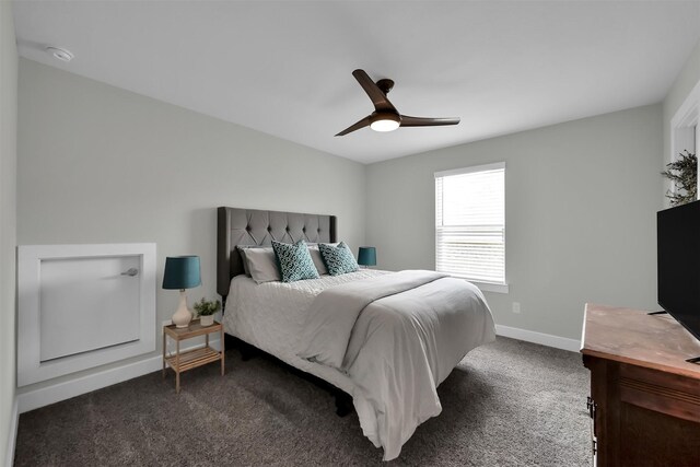 2411 Sunset Mist Ln, Conroe, TX 77304 - bedroom with dark carpet and a ceiling fan