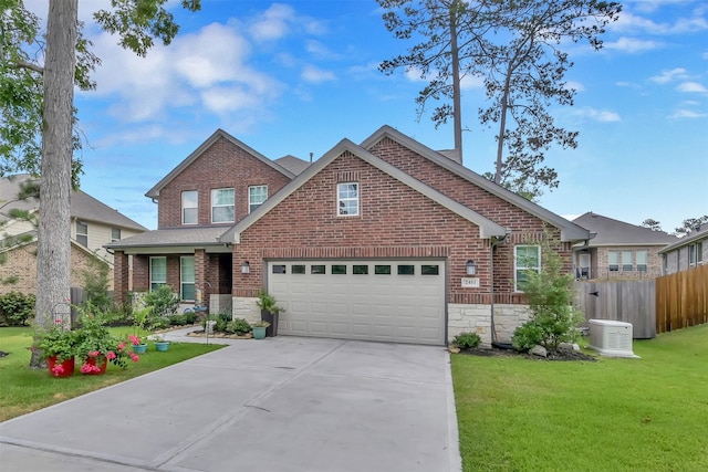 2411 Sunset Mist Ln, Conroe, TX 77304 - view of front facade featuring concrete driveway, brick siding, and stone siding