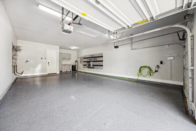 10306 Grape Creek Grove Ln, Cypress, TX 77433 - garage featuring baseboards and a garage door opener
