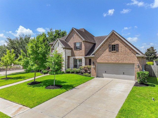 2424 Prairie Mist Ln, Friendswood, TX 77546 - traditional-style house with brick siding, driveway, a garage, and stone siding