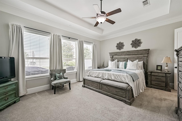 2424 Prairie Mist Ln, Friendswood, TX 77546 - bedroom featuring light carpet, a tray ceiling, crown molding, and a ceiling fan