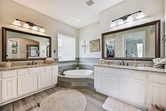 2424 Prairie Mist Ln, Friendswood, TX 77546 - full bath featuring plenty of natural light, a garden tub, two vanities, and a shower