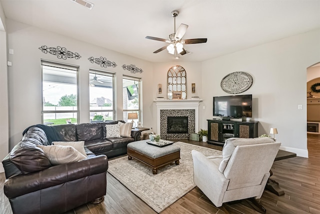 2424 Prairie Mist Ln, Friendswood, TX 77546 - living area with a ceiling fan, wood finished floors, a fireplace, and arched walkways