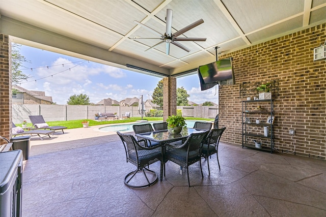 2424 Prairie Mist Ln, Friendswood, TX 77546 - fenced backyard featuring ceiling fan, a patio area, and outdoor dining area