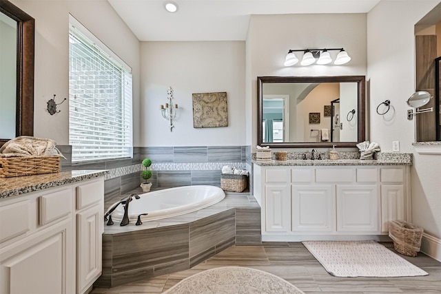 2424 Prairie Mist Ln, Friendswood, TX 77546 - bathroom with vanity, a garden tub, and recessed lighting