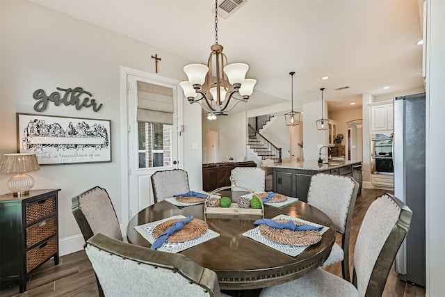 2424 Prairie Mist Ln, Friendswood, TX 77546 - dining room with stairs, dark wood finished floors, a chandelier, and recessed lighting