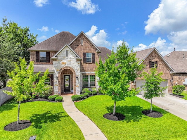 2424 Prairie Mist Ln, Friendswood, TX 77546 - view of front facade featuring brick siding, stone siding, concrete driveway, and roof with shingles
