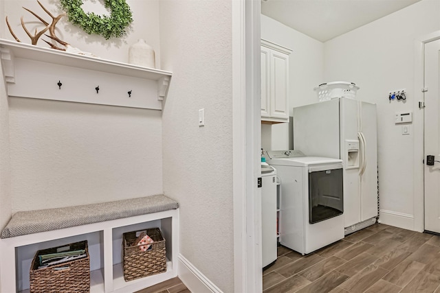 2424 Prairie Mist Ln, Friendswood, TX 77546 - laundry room with cabinet space, washer and dryer, and wood finished floors