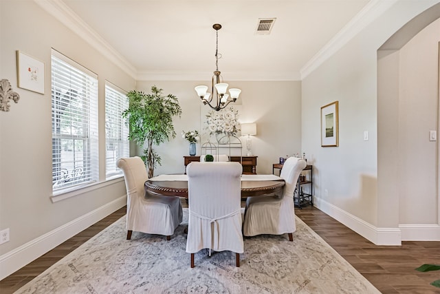 2424 Prairie Mist Ln, Friendswood, TX 77546 - dining space with a chandelier, wood finished floors, and ornamental molding