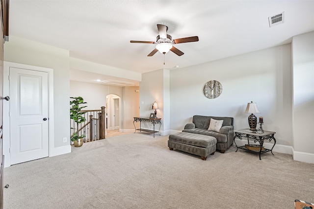 2424 Prairie Mist Ln, Friendswood, TX 77546 - sitting room featuring arched walkways, a ceiling fan, an upstairs landing, and carpet floors