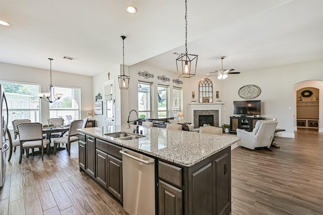 2424 Prairie Mist Ln, Friendswood, TX 77546 - kitchen featuring dishwasher, ceiling fan, a tile fireplace, wood finished floors, and recessed lighting