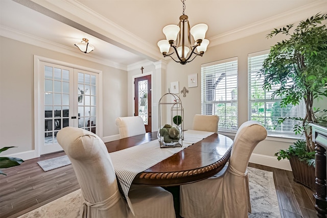 2424 Prairie Mist Ln, Friendswood, TX 77546 - dining space featuring crown molding, a chandelier, dark wood-style floors, and french doors
