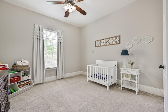 2424 Prairie Mist Ln, Friendswood, TX 77546 - bedroom with a nursery area, carpet floors, and a ceiling fan