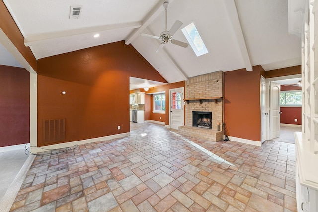 12706 Drumwood Ln, Cypress, TX 77429 - unfurnished living room with a skylight, beam ceiling, a ceiling fan, high vaulted ceiling, and a brick fireplace
