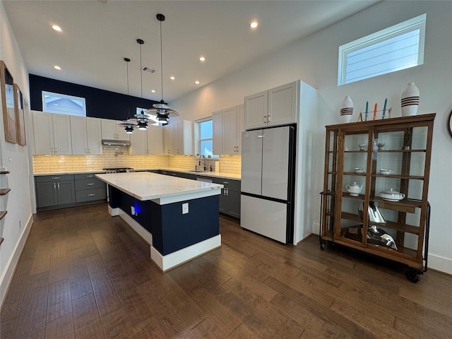 418 Bayou St, Houston, TX 77020 - kitchen featuring freestanding refrigerator, gray cabinets, a center island, backsplash, and recessed lighting